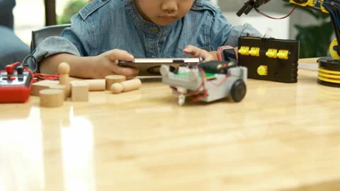 Primary School Girl Using App to Control Car in STEM Class Stock Footage 270478030