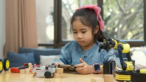 Primary School Girl Using App to Control Car in STEM Class Stock Footage 270478206
