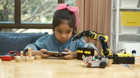 Primary School Girl Using App to Control Car in STEM Class Stock Footage 270478254