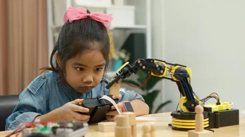 Primary School Girl Using App to Control Car in STEM Class Stock Footage 270478583
