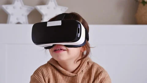Primary school girl using VR glasses and exploring virtual worlds Video stock 151930630
