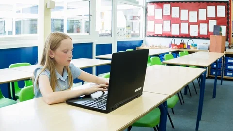 Primary school girl working on computer after class Video stock 104237668