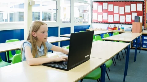 Primary school girl working on computer after class Video stock 104238046