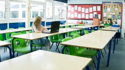 Primary school girl working on computer after class Video stock 104238507