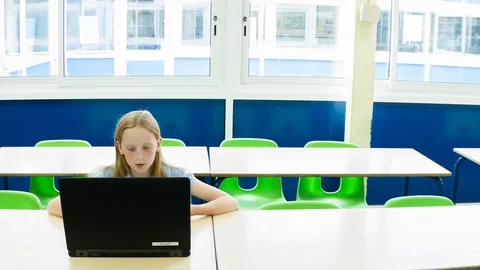Primary school girl working on computer after class Video stock 104239184
