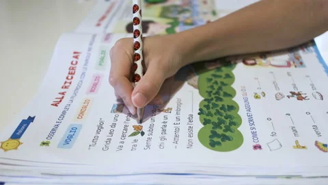 Primary school kid do summer homework,home family education after covid disease Stock Footage 134578651