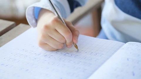 Primary school kid hand while doing maths homework writing,education lifestyle Video stock 155288883