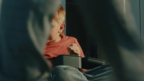 Primary School Student Enjoying Packed Lunch with Reusable Food Container and Stock Footage 342030810