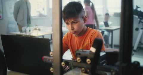 Primary School Student Learning Programming in Modern Classroom, Writing Code Stock Footage 311674187