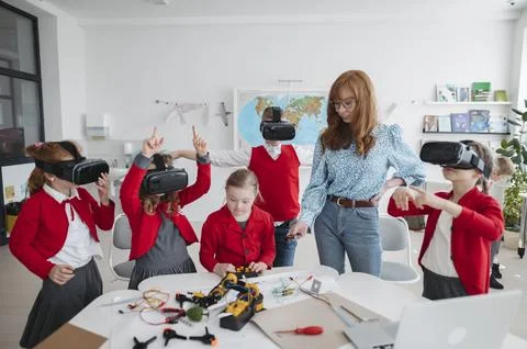 Primary school students learning robotics and technology during STEM class. Stock Photos