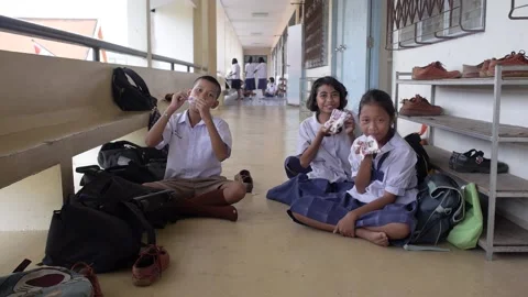 Primary School Students Sitting on the Floor and Joyfully Drinking Milk Stock Footage 156755456