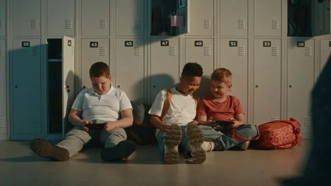 Primary School Students Using Handheld Digital Devices During School Break Stock Footage 342034380