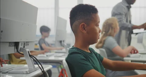Primary School Students Working on Creative Projects on Computers. Diverse Kids Stock Footage 316298387