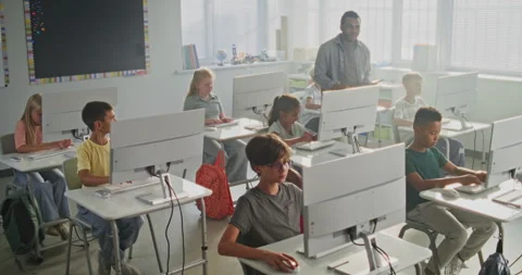 Primary School Students Working on Creative Projects on Computers. Teacher Stock Footage 316301593