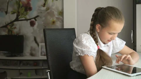 Primary schoolgirl using a digital tablet computer Stock Footage 64889380