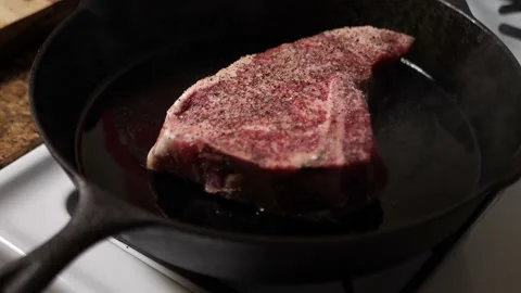 Prime Cut T-Bone Steak On Home Cast Iron Skillet 4k 60fps Stock Footage 130912323