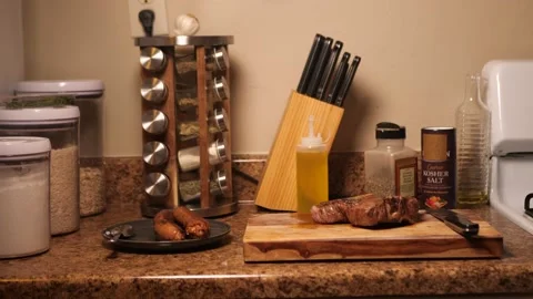 Prime Cut T-Bone Steak Sitting On Cutting Board Home Kitchen 4k 60fps Stock Footage 130912335