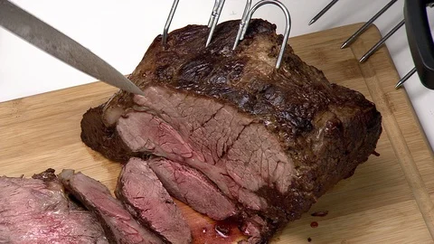 Prime rib roast. Multiple slices with large carving knife Stock Footage 102136977