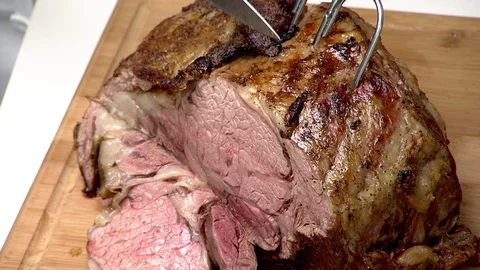 Prime rib roast. Single slice revealing medium rare center Stock Footage 102136885