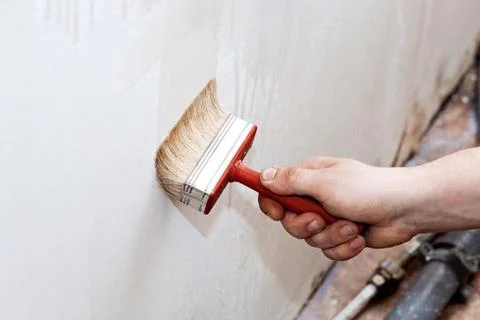 Priming of the wall with a brush Stock Photos