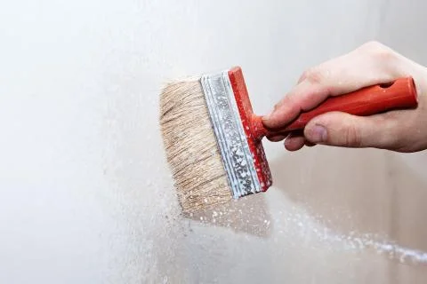 Priming of the wall with a brush Stock-Fotos