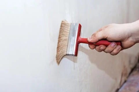 Priming of the wall with a brush Stock-Fotos