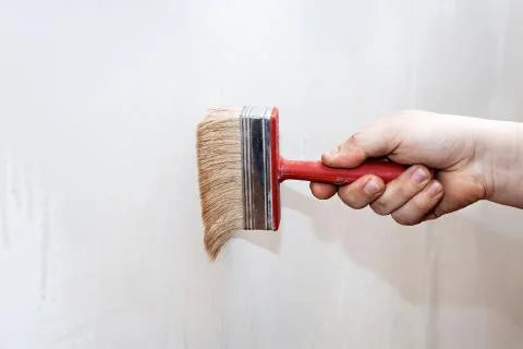 Priming of the wall with a brush Stock Photos