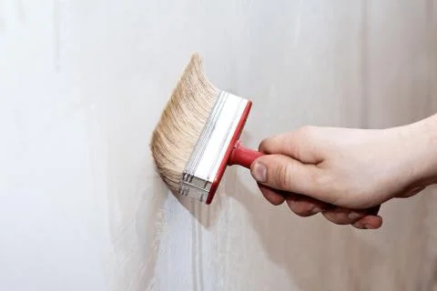 Priming of the wall with a brush Stock Photos