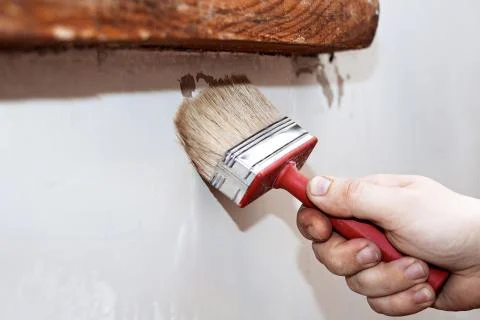Priming of the wall with a brush Stock Photos