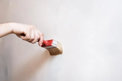Priming of the wall with a brush Stock Photos