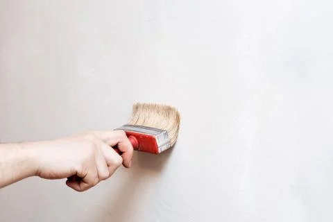 Priming of the wall with a brush Stock Photos
