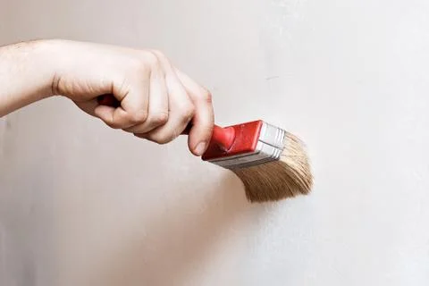 Priming of the wall with a brush Foto stock