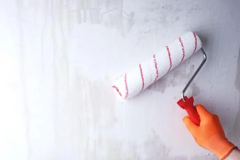 Priming the wall with roller Фото
