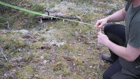 Primitive Camping Setup Using Rock to Fix Tent Stake Outdoors 库存影片 334047706