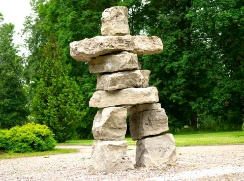 Primitive simple big huge man sculpture from bright square stones park summer Stock Photos