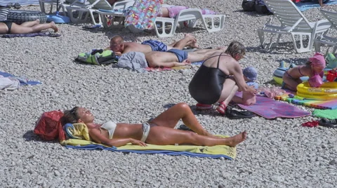 Primosten sunbathing on the beach Stock Footage 45827718