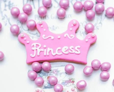 Princess Cookee on white ceramic surface Stock Photos