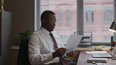 Principal Printing Documents at Desk in School Office Stock Footage 322577996