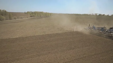 Principle of operation of sowing machine to tractor in field Stock Footage 64591310