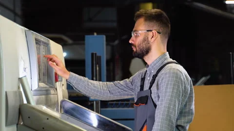 Print house worker setting parameters on modern offset printing machine Stock Footage 257039322