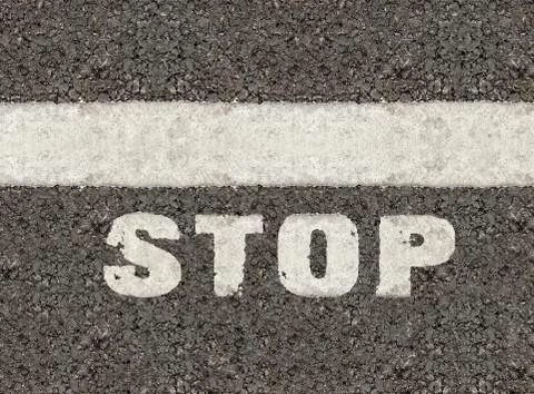 Print stop on asphalt background Stock Photos