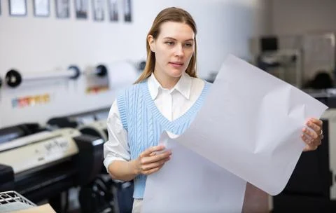 Print worker controlling printing process on modern offset machine in print shop Stock Photos