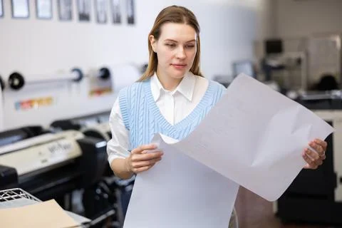 Print worker controlling printing process on modern offset machine in print shop Stock Photos