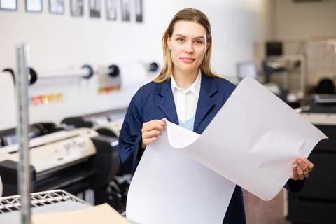 Print worker controlling printing process on modern offset machine in print shop Stock Photos