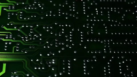 Printed Circuit Board along which a beam of light green moves. Macro. Closeup Stock Footage 169240620