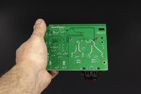 Printed circuit board green in the hand of the master Stock Photos