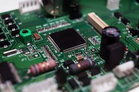 Printed Circuit Board with many electrical components. Selected focus. Stock Photos
