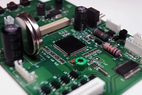 Printed Circuit Board with many electrical components. Selected focus. Stock Photos