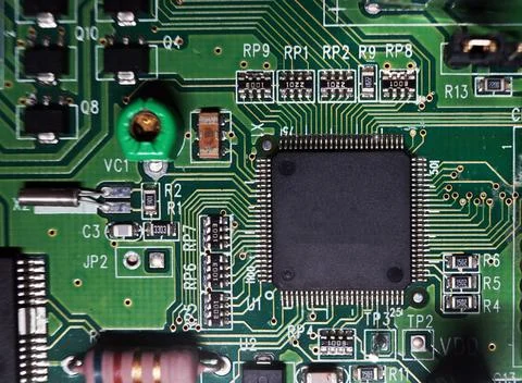 Printed Circuit Board with many electrical components. Selected focus. Stock Photos
