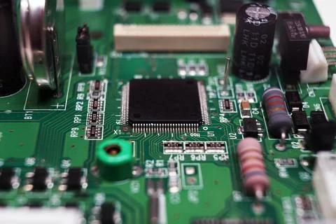 Printed Circuit Board with many electrical components. Selected focus. Stock Photos